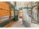 Basement with spiral staircase and windows with protective plywood covers, offering potential for customization and natural light at 2106 4Th Ne St, Hickory, NC 28601