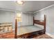 Basement bedroom with a vintage metal frame bed and a small, high window at 2106 4Th Ne St, Hickory, NC 28601