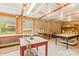 A well-lit basement with large windows, concrete walls, brick floors, and multiple work tables at 2106 4Th Ne St, Hickory, NC 28601