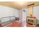 Basement area with painted concrete walls, vintage furnace, and quirky elements, including an original metal-framed sofa at 2106 4Th Ne St, Hickory, NC 28601
