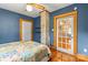 Charming bedroom featuring hardwood floors, a decorative brick chimney, and a patchwork quilt on the bed at 2106 4Th Ne St, Hickory, NC 28601