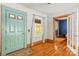 Inviting entryway with a teal front door, hardwood floors, and views into the living spaces at 2106 4Th Ne St, Hickory, NC 28601