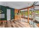 Living area with unique shelves, light colored wood floors, and a window overlooking trees at 2106 4Th Ne St, Hickory, NC 28601