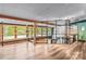 Open living room with stylish built-in shelving, exposed beams, and large windows overlooking the greenery at 2106 4Th Ne St, Hickory, NC 28601
