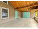 Covered patio featuring concrete floors, exposed beams, and a teal door at 2106 4Th Ne St, Hickory, NC 28601