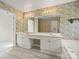 A functional bathroom space with dual sinks, a vanity, and a large mirror for grooming, complemented by decorative wall coverings at 213 Walnut Point Dr, Matthews, NC 28105