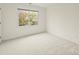 A bright bedroom with a large window, and cozy carpeting provides a comfortable, private space to rest and relax at 213 Walnut Point Dr, Matthews, NC 28105