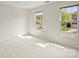 Bright, carpeted bedroom with two windows offers a comfortable retreat filled with natural light and views of the surrounding neighborhood at 213 Walnut Point Dr, Matthews, NC 28105