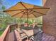 Spacious outdoor deck features dining table and an umbrella, perfect for outdoor entertaining and enjoying the scenic views at 213 Walnut Point Dr, Matthews, NC 28105
