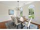 Elegant dining room with hardwood floors, statement lighting, and stylish seating for memorable gatherings at 213 Walnut Point Dr, Matthews, NC 28105