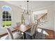 Elegant dining room with hardwood floors, statement lighting, and stylish seating for memorable gatherings at 213 Walnut Point Dr, Matthews, NC 28105