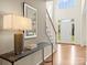 Bright foyer featuring hardwood floors, white staircase, and console table creating a welcoming atmosphere at 213 Walnut Point Dr, Matthews, NC 28105