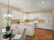 Eat-in kitchen featuring white cabinets, stainless appliances, and hardwood floors at 213 Walnut Point Dr, Matthews, NC 28105
