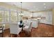 Bright eat-in kitchen features white cabinetry, granite countertops, and stainless steel appliances at 213 Walnut Point Dr, Matthews, NC 28105