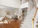 Open living space with hardwood floors, a staircase, and stylish seating creates a welcoming atmosphere at 213 Walnut Point Dr, Matthews, NC 28105