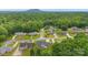 Aerial view of houses with beautiful landscaping in a leafy suburban neighborhood under a sunny sky at 2459 Glenridge Dr, Gastonia, NC 28054
