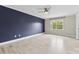 Spacious bedroom with a navy accent wall, ceiling fan, and lots of light at 2459 Glenridge Dr, Gastonia, NC 28054