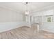 Dining area with wainscoting, open floor plan, and view to the front entry, and living area at 2459 Glenridge Dr, Gastonia, NC 28054