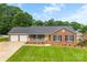 Charming brick ranch home features a two-car garage, inviting front porch, and well-manicured lawn at 2459 Glenridge Dr, Gastonia, NC 28054