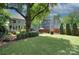 Spacious backyard with outdoor seating area, privacy fence, and mature trees at 2729 Clemson Ave, Charlotte, NC 28205