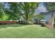 A large backyard with a patio and a seating area and large shade trees at 2729 Clemson Ave, Charlotte, NC 28205