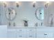 Bathroom featuring double sink vanity with granite countertop and round mirrors at 2729 Clemson Ave, Charlotte, NC 28205