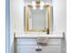 Bathroom with white cabinets, a marble countertop, modern fixtures, and a stylish gold framed mirror at 2729 Clemson Ave, Charlotte, NC 28205