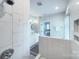 Bright bathroom featuring marble shower with glass door and double sink vanity at 2729 Clemson Ave, Charlotte, NC 28205