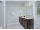 Bathroom with granite countertop, dual sinks, vanity, and modern fixtures at 2729 Clemson Ave, Charlotte, NC 28205