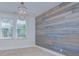 Bedroom featuring an accent wall, chandelier, and natural light at 2729 Clemson Ave, Charlotte, NC 28205