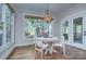 Bright dining area with hardwood floors, chandelier, and large windows providing abundant natural light at 2729 Clemson Ave, Charlotte, NC 28205