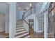 Bright foyer features a staircase with elegant wood trim, complemented by hardwood floors, and transom windows at 2729 Clemson Ave, Charlotte, NC 28205
