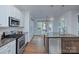Stylish kitchen with stainless appliances and granite countertops flows seamlessly into adjacent breakfast nook with natural light at 2729 Clemson Ave, Charlotte, NC 28205