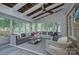 Bright sunroom features a beamed ceiling, large windows, and comfortable seating arrangements at 2729 Clemson Ave, Charlotte, NC 28205