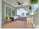 Relaxing outdoor porch with comfortable wicker seating, ceiling fan, and stylish decor for tranquil enjoyment at 2729 Clemson Ave, Charlotte, NC 28205