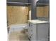 Well-maintained bathroom featuring a granite vanity top and shower-tub combo at 2831 Denview Ln, Charlotte, NC 28208