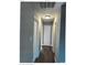 Clean hallway with freshly painted walls and shiny hardwood floors at 2831 Denview Ln, Charlotte, NC 28208