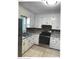 Traditional kitchen with white cabinets, stainless steel appliances, and stone countertops at 2831 Denview Ln, Charlotte, NC 28208