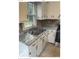 Bright kitchen with updated countertops, a stainless steel sink, and white cabinetry at 2831 Denview Ln, Charlotte, NC 28208