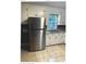 Kitchen featuring stainless steel refrigerator and sink with white cabinets and tile flooring at 2831 Denview Ln, Charlotte, NC 28208