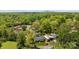 Scenic aerial view of modern home nestled among lush green trees with skyline views in the background at 3036 Palm Ave, Charlotte, NC 28205