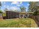 This home features a large backyard with a screened-in porch and a well-maintained lawn at 3036 Palm Ave, Charlotte, NC 28205