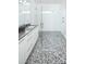 Modern bathroom featuring glass shower, sleek white vanity, and stylish mosaic tile flooring at 3036 Palm Ave, Charlotte, NC 28205