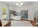 Bright bedroom with a forest mural, stylish light fixture, and ample natural light at 3036 Palm Ave, Charlotte, NC 28205