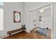 Inviting entryway featuring a bench, a mirror, and hardwood floors leading to a bright interior space at 3036 Palm Ave, Charlotte, NC 28205