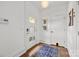 Light and bright entry foyer with white walls, hardwood floors and a stylish entry door at 3036 Palm Ave, Charlotte, NC 28205
