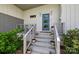 Stylish home entrance featuring a blue door, concrete steps, and modern metal railings at 3036 Palm Ave, Charlotte, NC 28205