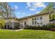 Modern home with sleek lines, neutral siding, gray brick accents, and a beautifully landscaped front yard at 3036 Palm Ave, Charlotte, NC 28205