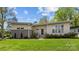 Contemporary home showcasing modern architecture, a well-manicured lawn, and vibrant landscaping at 3036 Palm Ave, Charlotte, NC 28205