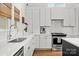 Bright, modern kitchen with white cabinets, marble countertops, and stainless steel appliances at 3036 Palm Ave, Charlotte, NC 28205